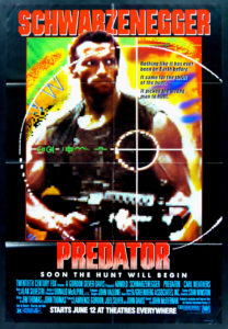 Arnold Schwarzenegger stands in the crosshairs of an alien predator.