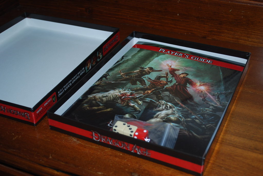 Opening the boxed reveals a thin players guide booklet as well as a plastic bag containing three six sided dice (two white, one red).