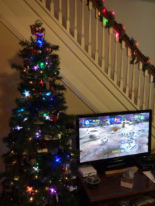 The geek Christmas tree next to a television displaying the LEGO Clone Wars video game.