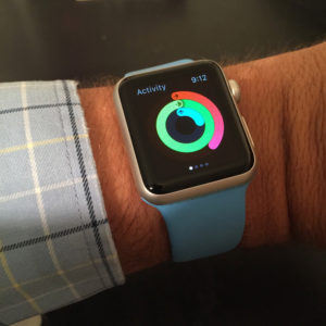 A close-up view of the apple watch displaying the three concentric circles of the activity app.
