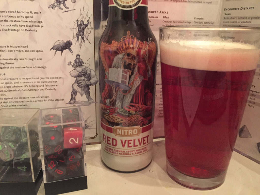 A close-up of a beer with an undead king sitting on a throne, with a glass of reddish beer near by in a pint glass.