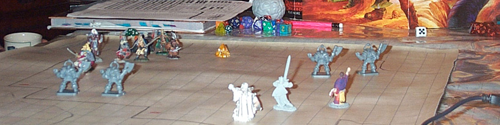 A close-up view of small fantasy figures on a gridded battle map.