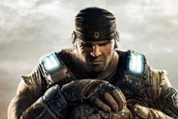 A soldier stands with his gun before him, his hands resting on its grip, while clouds gather behind him.
