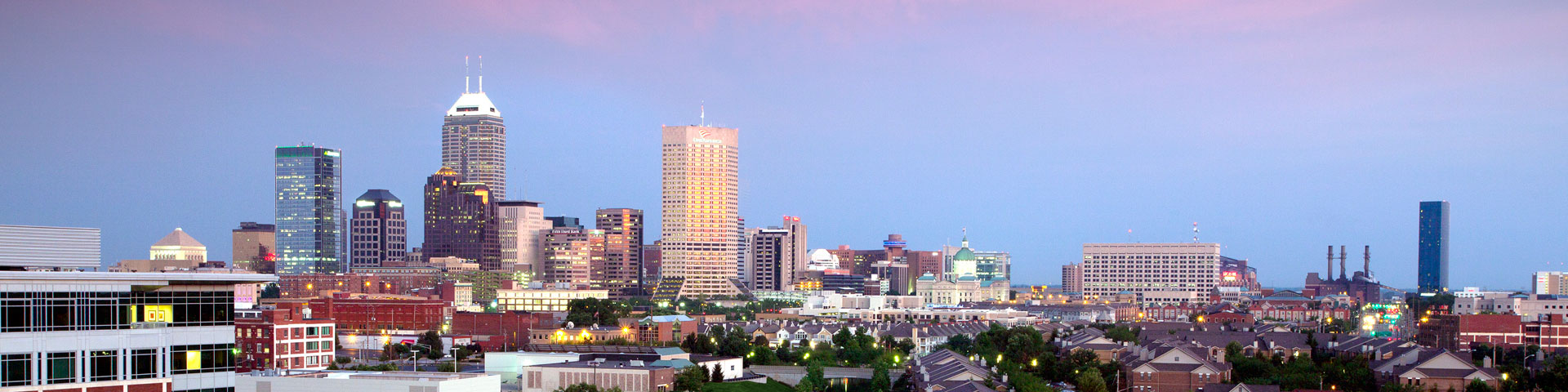 The Indianapolis skyline, with a blue-pink sky in the background.