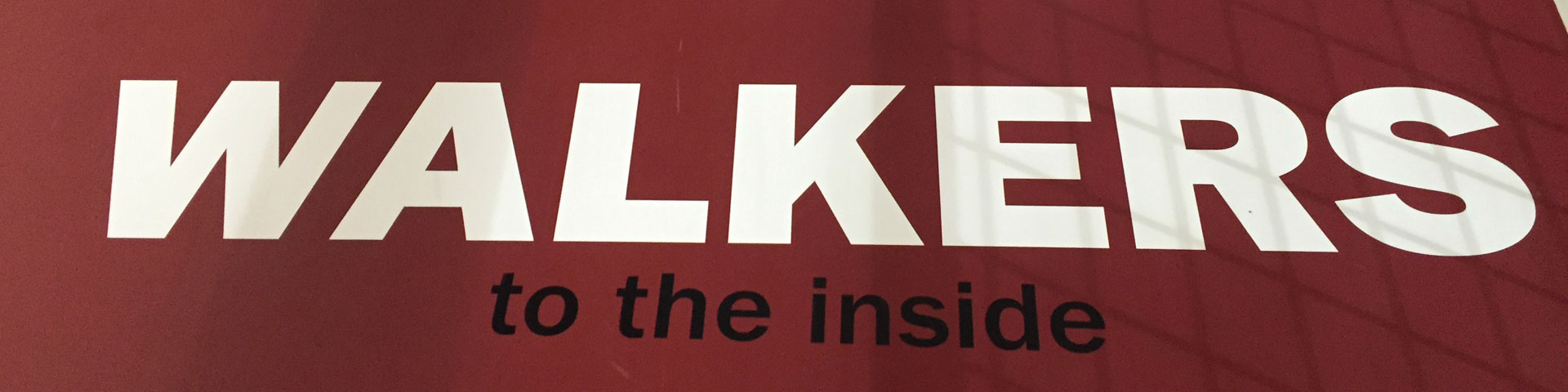 "Walkers: Stay to the Inside" is the text that appears on this red indoor running track.