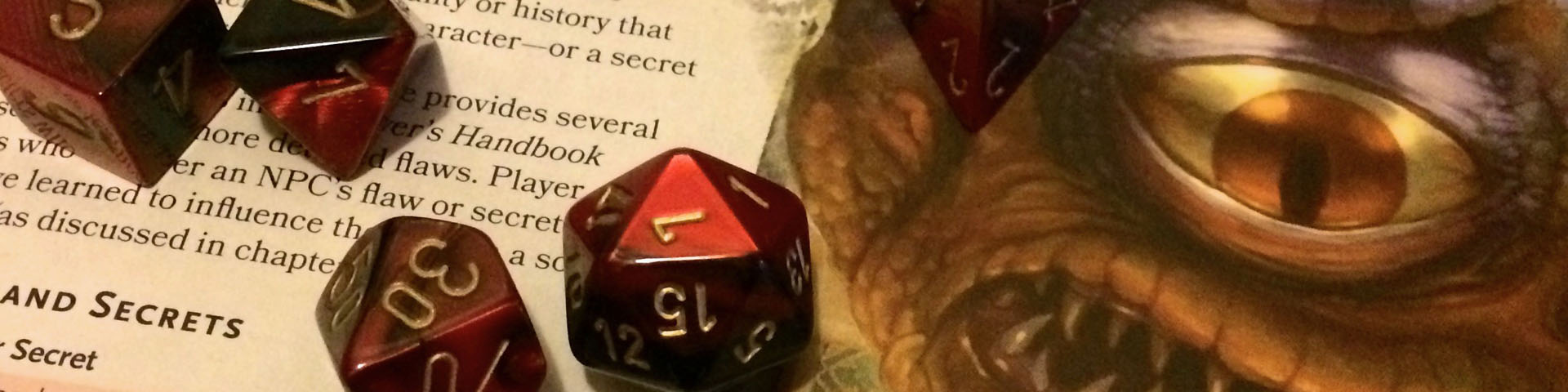 Red and black dice rest against a page of the Dungeon Master's Guide.