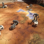 Four mechs battle on an orange-yellow hexagonal map. One of the mechs has been knocked down to represent it was badly damaged.