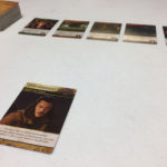 A card representing Bard, one of the characters from the Hobbit, appears in the foreground. Other cards appear in the distance.
