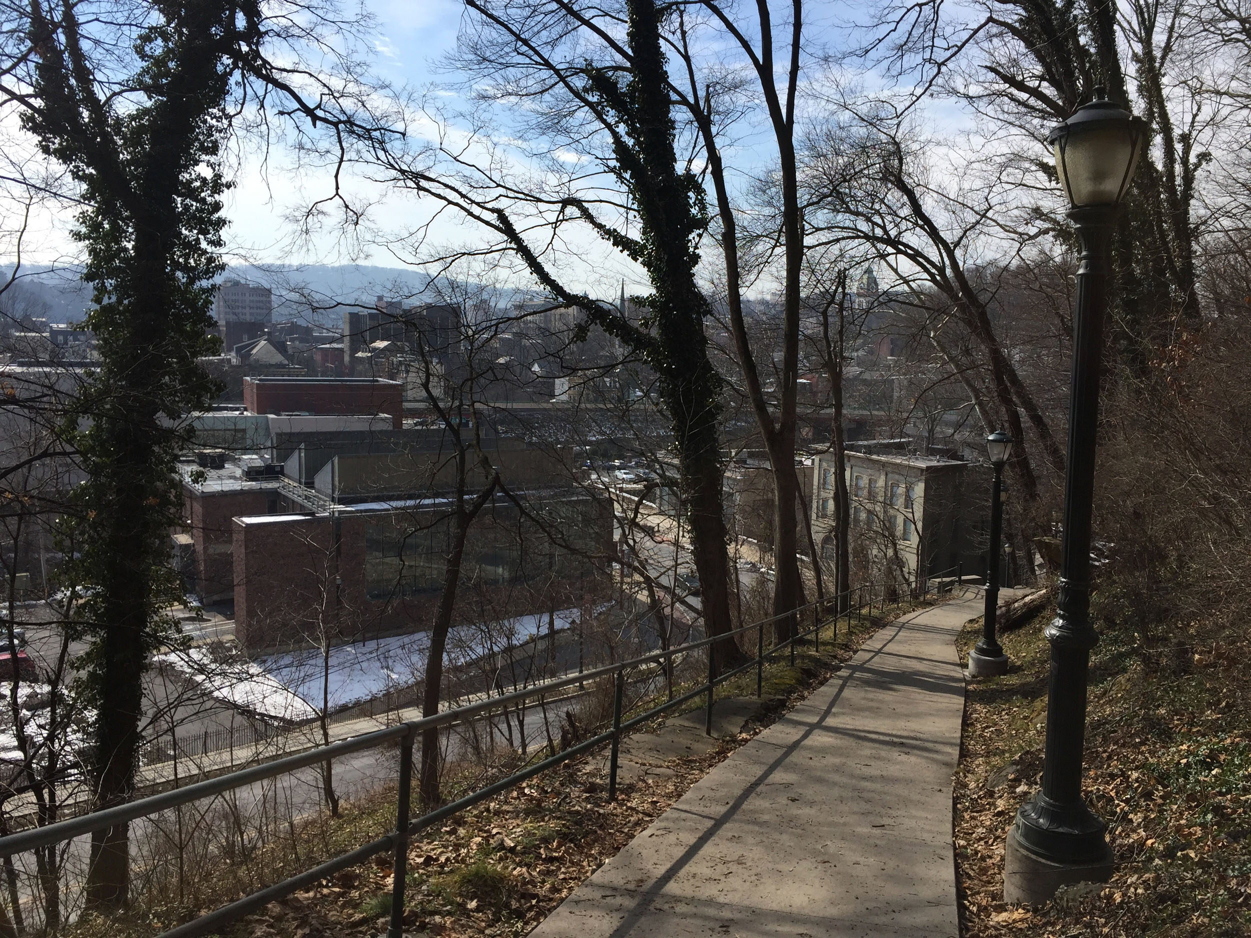Bare trees and a concrete path overlook the city of Easton.