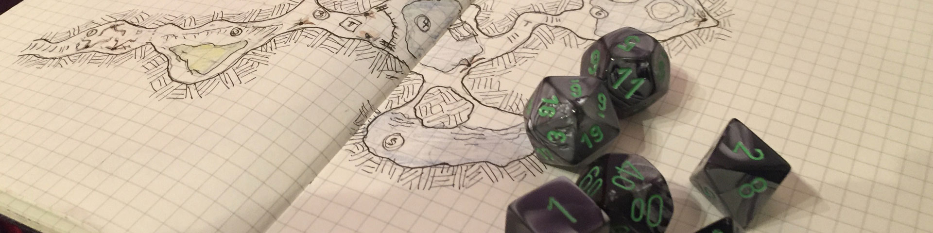 Green and grey dice sit atop a hand-drawn dungeon map.
