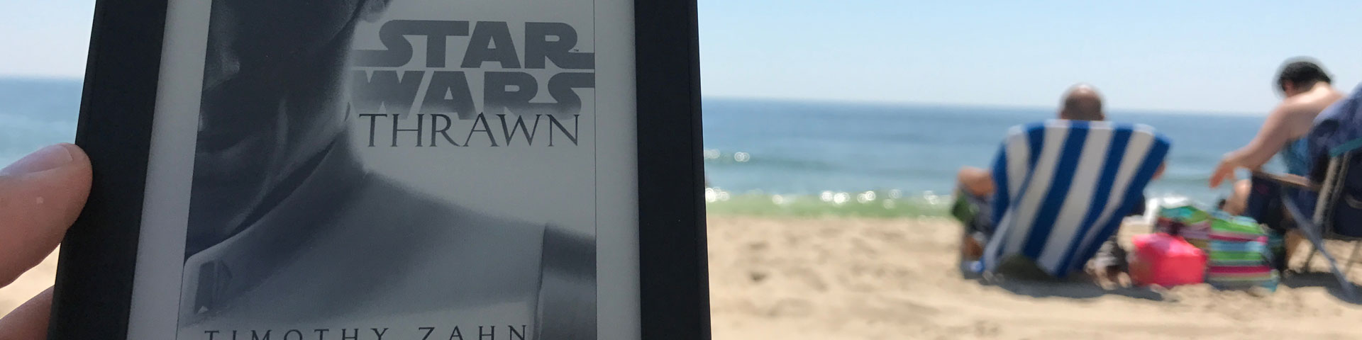 A photo of the Kindle cover for Thrawn, with the Jersey shore in the background.