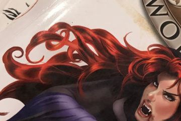 A stack of role-playing game books. A redheaded vampire appears on the cover of one them.