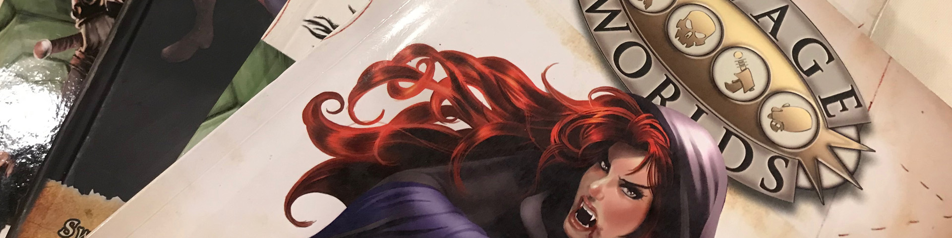 A stack of role-playing game books. A redheaded vampire appears on the cover of one them.