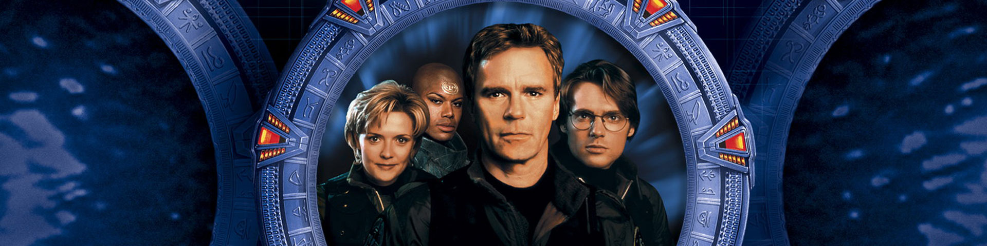 Four actors - one woman and three men - are centered on a large circular Stargate.