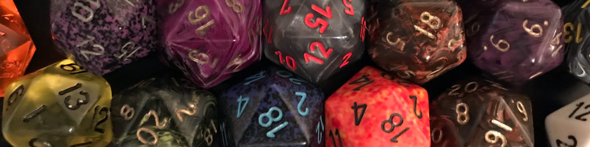 Two rows of different-colored twenty-sided dice.