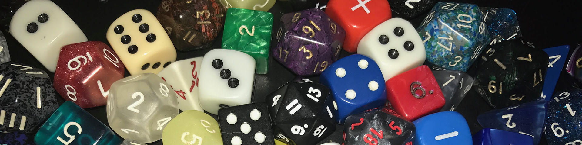 A collection of dice of different size and colors.