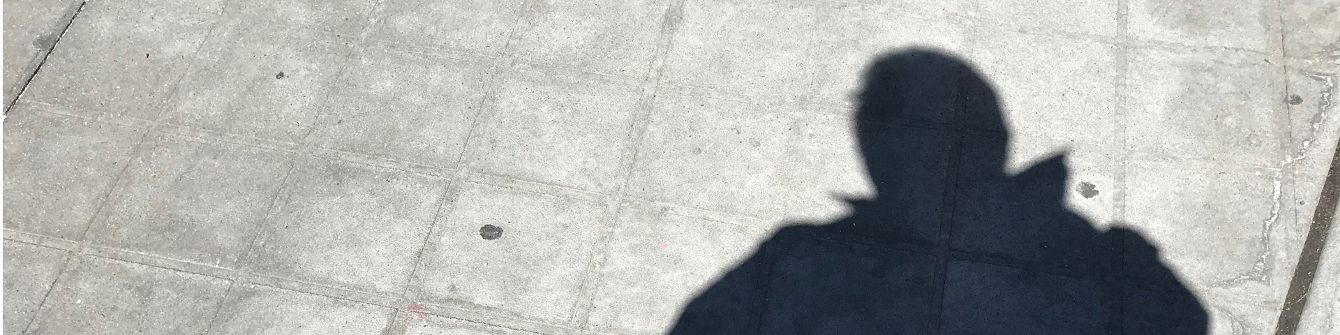 A man's shadow on a sidewalk
