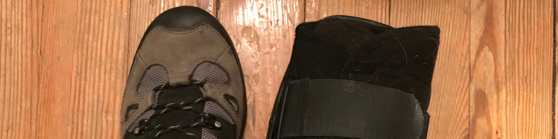 A picture of my left foot (wearing a hiking boot) and my right (wearing a structural boot)