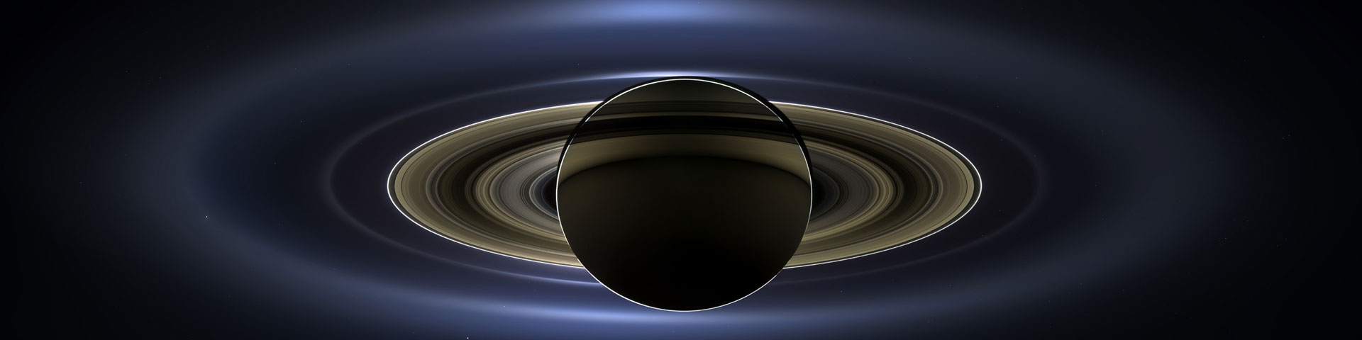 A view of Saturn backlit by the sun.