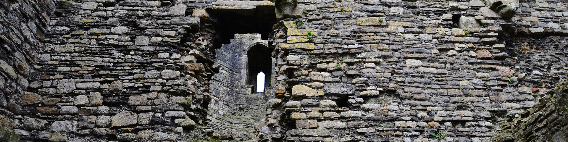 A series of stone walls, with archways leading onward.