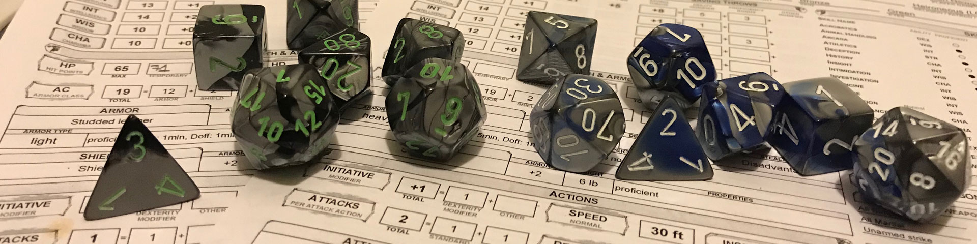 A close up view of dice sitting on a pair of character sheets.