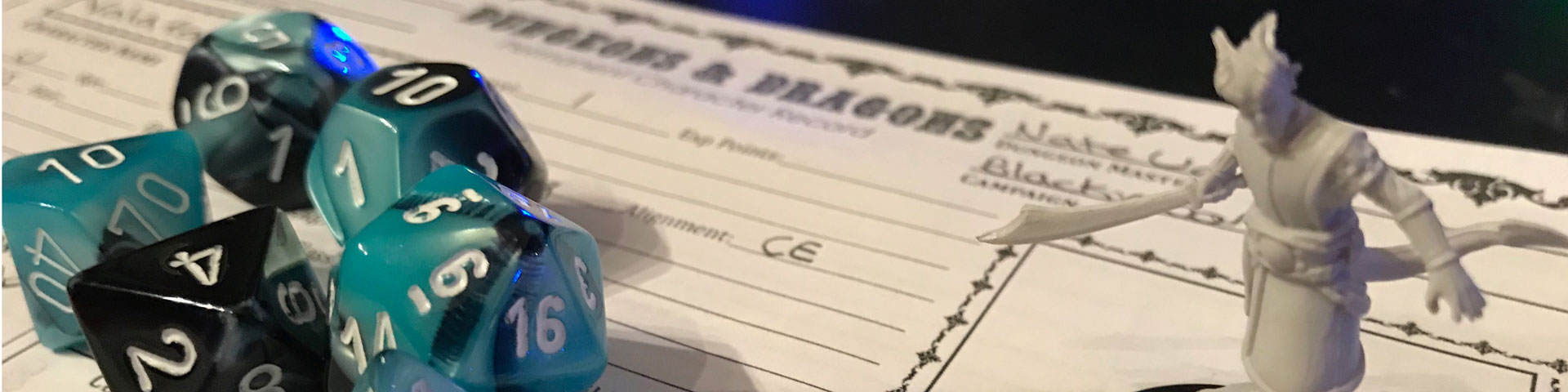 A close up view of blue/black dice and a tiefling warlock. In the background is an old-school style character sheet.
