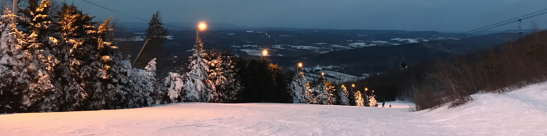 A view from the top of a ski sloop. The hills of Pennsylvania can be seen in the distance.