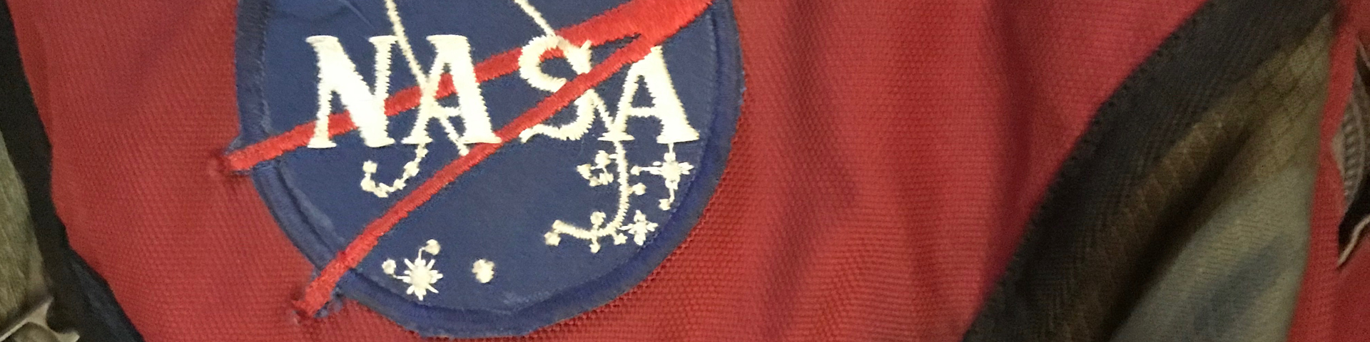 A close-up view of my old red backpack with a NASA patch on it.