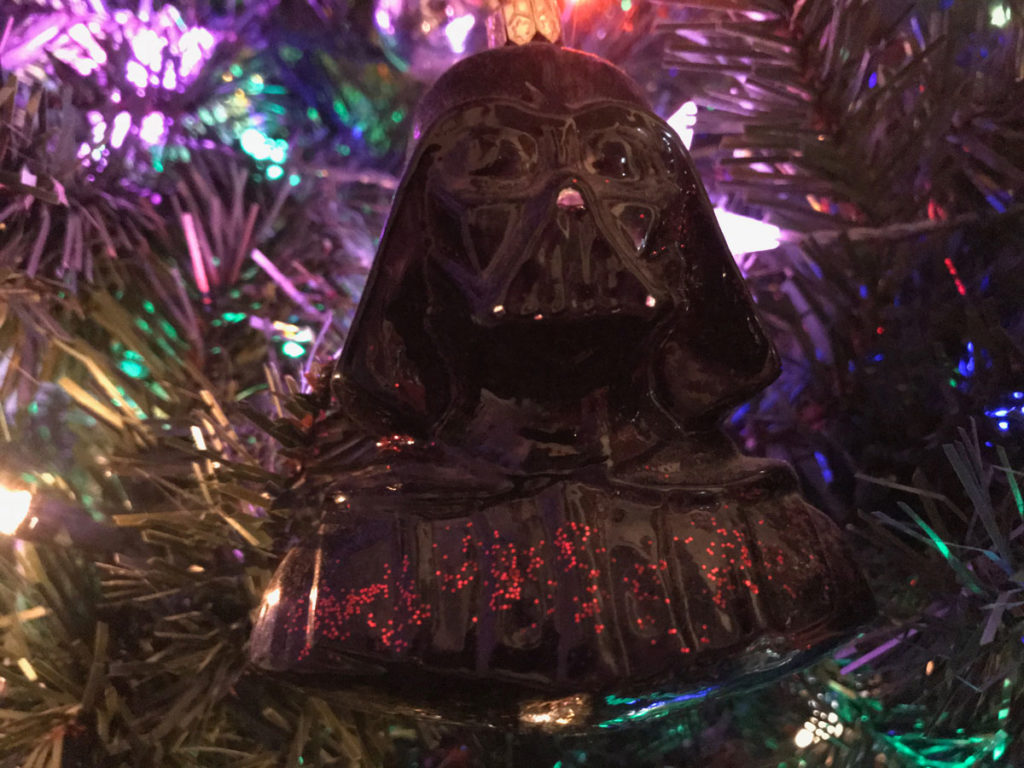 A black Darth Vader bust hands in a Christmas tree