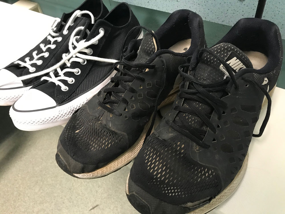 My new black-and-white Chucks appear on the left; my disintegrating black Nikes appear on the right.