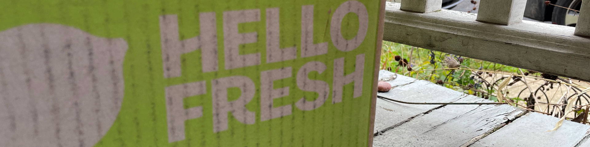A close-up of a green and grey Hello Fresh box.