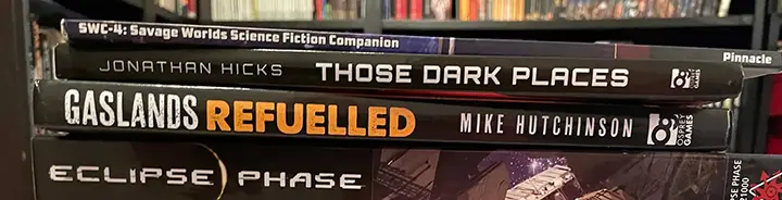 Several RPG books stacked on one of another.