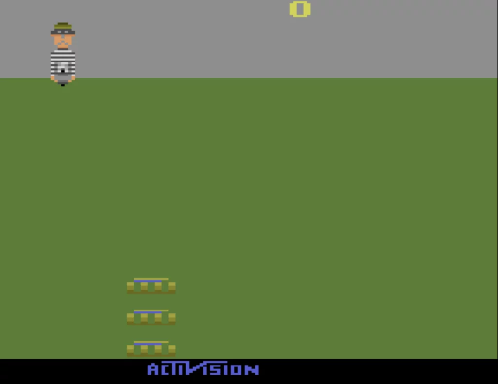 A bomber - in striped black and white clothes - holds a bomb and prepares to drop it. Three buckets appear below, ready to catch the bomb.